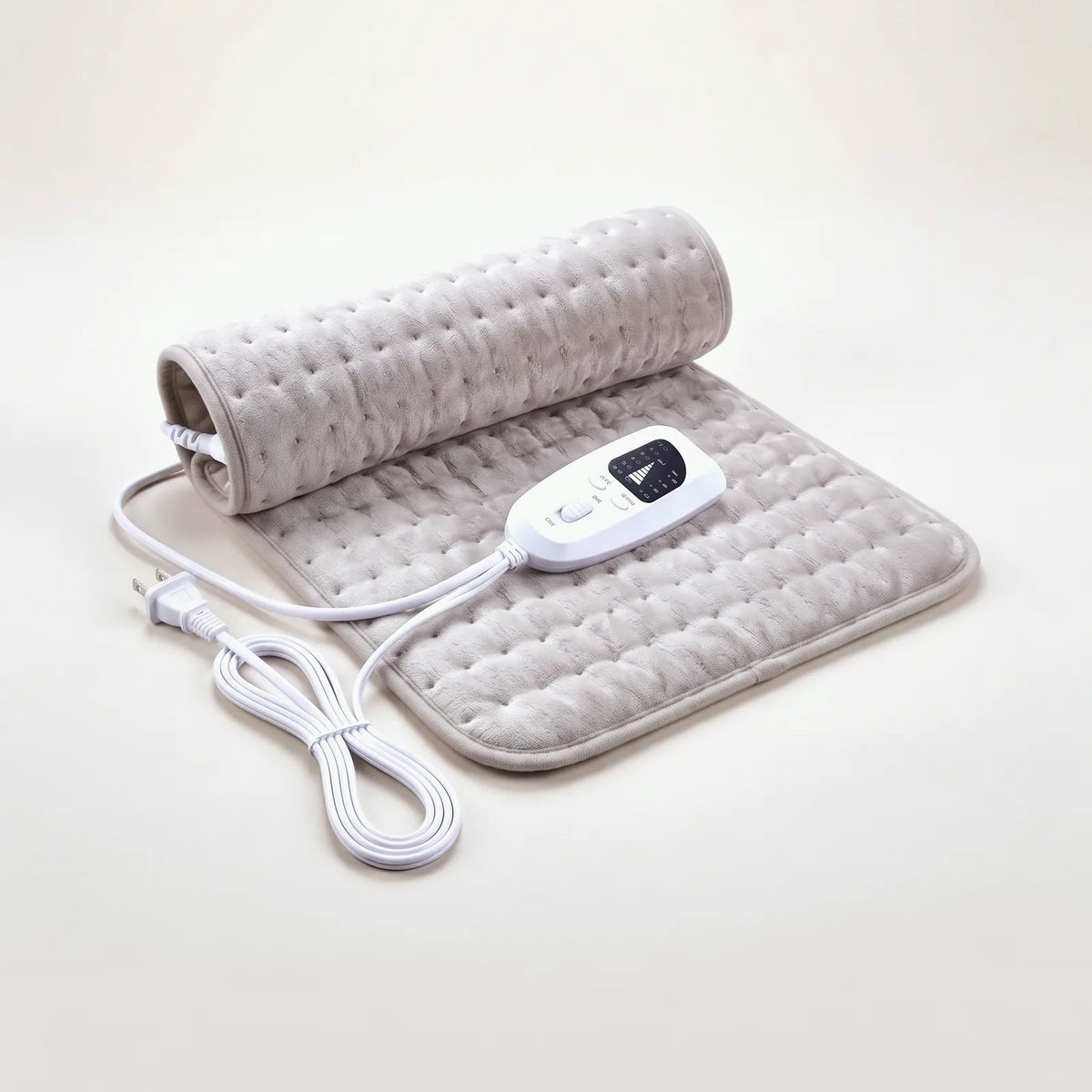 BergHeat Hearth heating pad in grey, half rolled, with hand controller and US plug